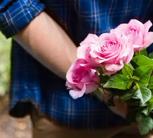 A bouquet held behind the back